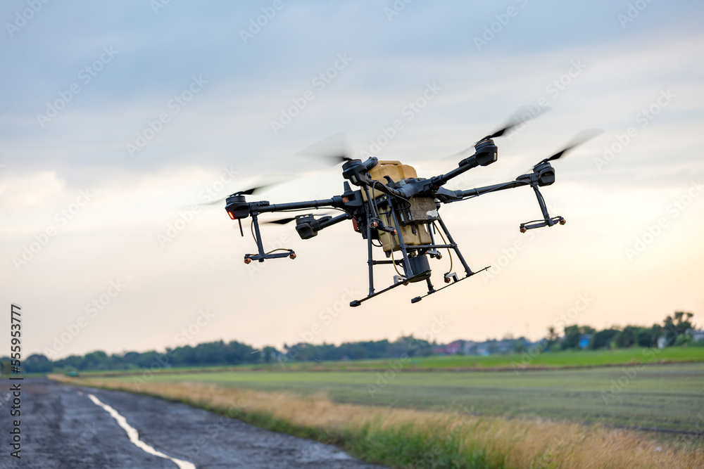 Modern smart farm with drone. Agriculture drone fly to Ready spray fertilizer on the rice fields. Modern smart farm with drone. Agriculture drone fly to Ready spray fertilizer on the rice fields.