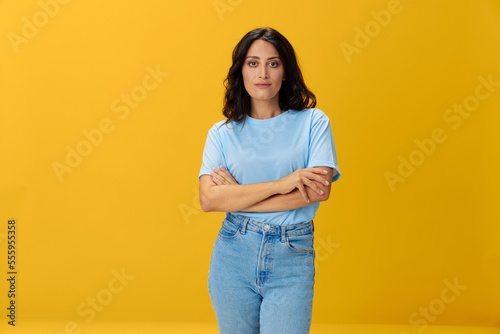 Woman signal smile with teeth emotion portrait in blue t-shirt on yellow background, hands up, surprise, lifestyle, copy space