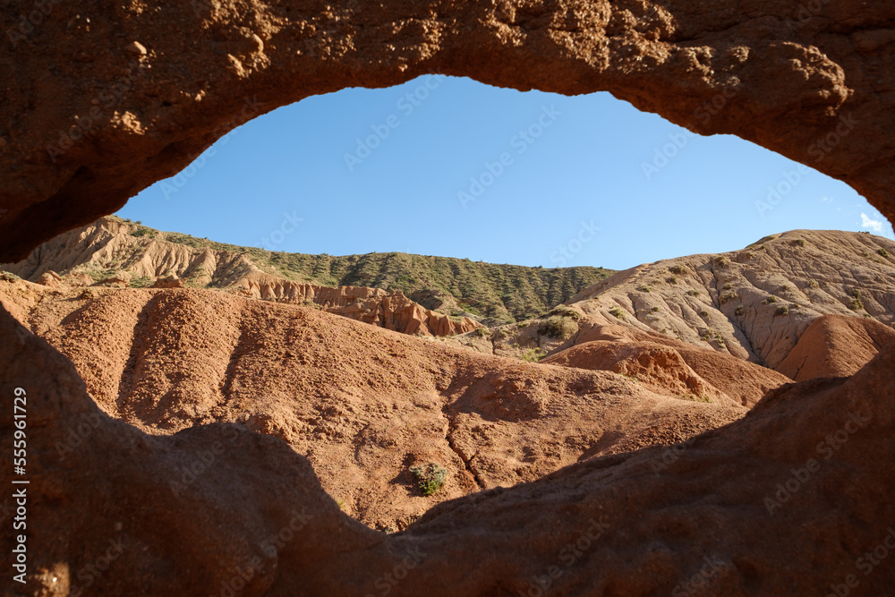 View through natural arch in the Skazka fairytale canyon close to lake Issyk-Kul, Tosor, Kyrgyzstan