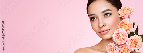 Portrait beautiful young woman with clean fresh skin. Model with healthy skin, close up portrait. Cosmetology, beauty and spa. Girl with a rose flower