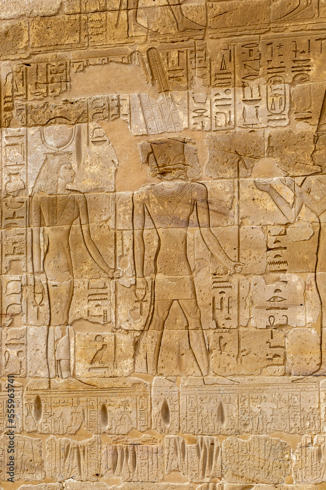 Hieroglypic painted carvings on wall at the ancient egyptian temple in Luxor. Egypt. Hieroglypic painted carvings on wall at the ancient egyptian temple in Luxor. Egypt.