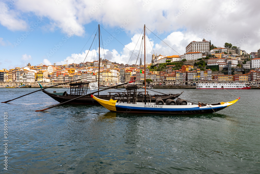 Traditional boats on Rio Douro. Portugal old town cityscape and Dom Luis I bridge in Porto, Portugal.