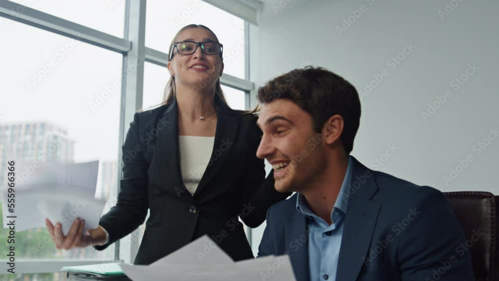 Happy business partners celebrate success closeup. Office colleagues check data Happy business partners celebrate success closeup. Office colleagues check data