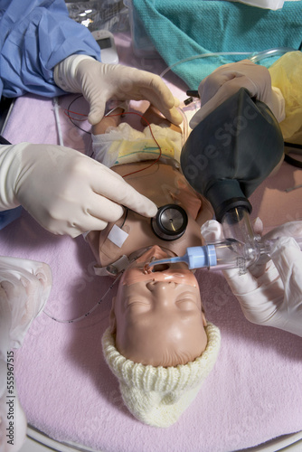 Nurses Practicing on Baby Mannequin