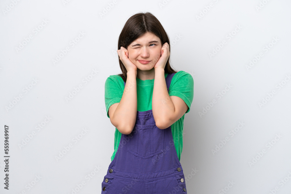 Young Russian woman isolated on blue background frustrated and covering ears Young Russian woman isolated on blue background frustrated and covering ears