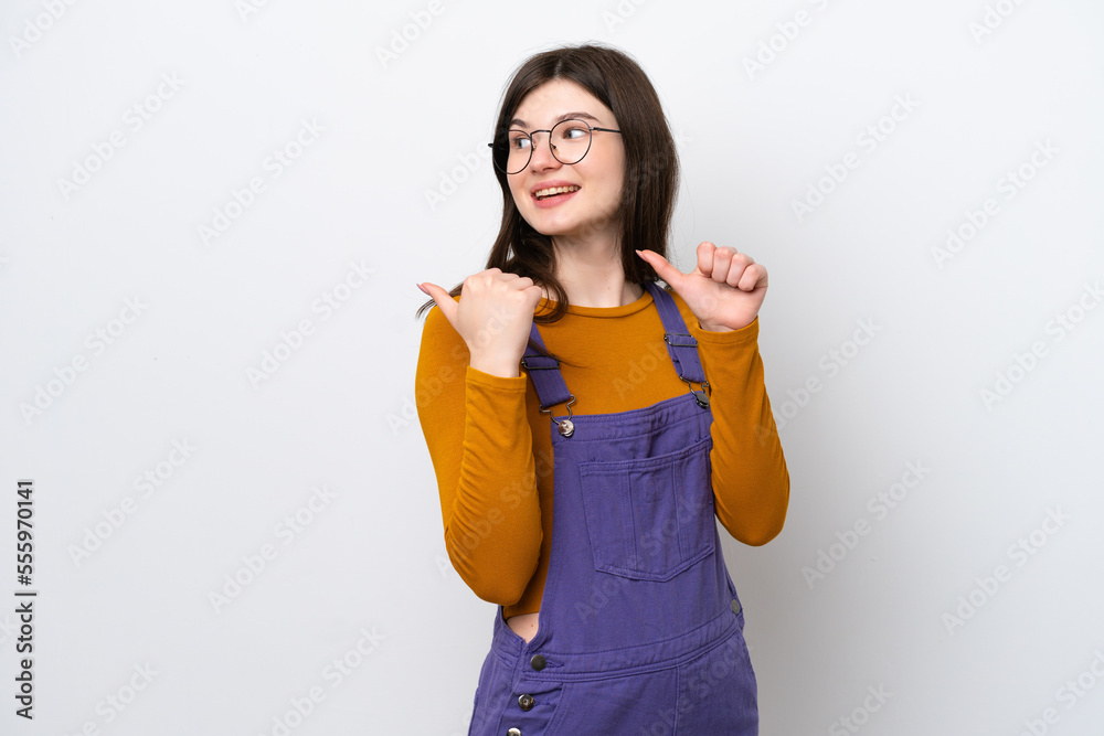 Young Russian woman isolated on blue background pointing to the side to present a product Young Russian woman isolated on blue background pointing to the side to present a product