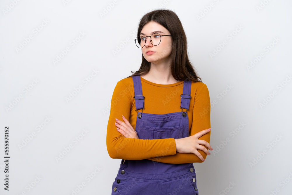 Young Russian woman isolated on blue background keeping the arms crossed