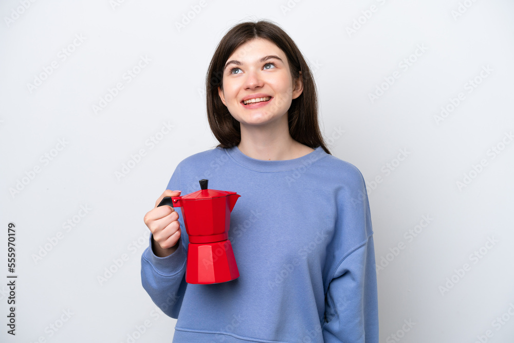 Young Russian woman holding coffee pot isolated on white background thinking an idea while looking up Young Russian woman holding coffee pot isolated on white background thinking an idea while looking up