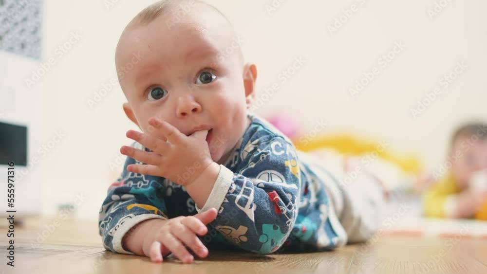 baby crawling. baby infant son makes the first move crawls on the floor for a toy. first steps happy family kid dream concept. son kid playing crawling in the room indoors at home