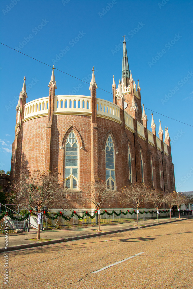 Exterior view of the St. Mary Basilica (Our Lady of Sorrows Cathedral) with semi-circular apsidal end, ornamental pinnacles, and buttresses erected in 1837 in Natchez, Mississippi, USA