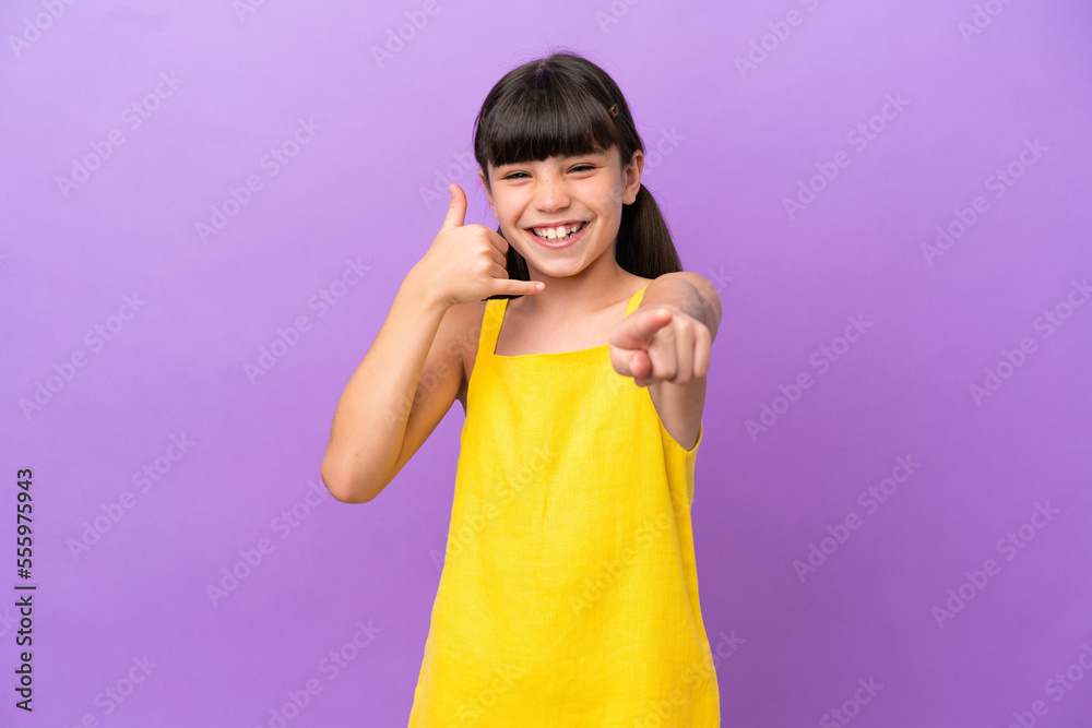 Little caucasian kid isolated on purple background making phone gesture and pointing front Little caucasian kid isolated on purple background making phone gesture and pointing front