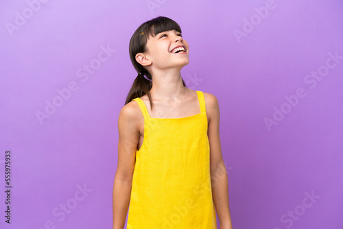 Little caucasian kid isolated on purple background laughing