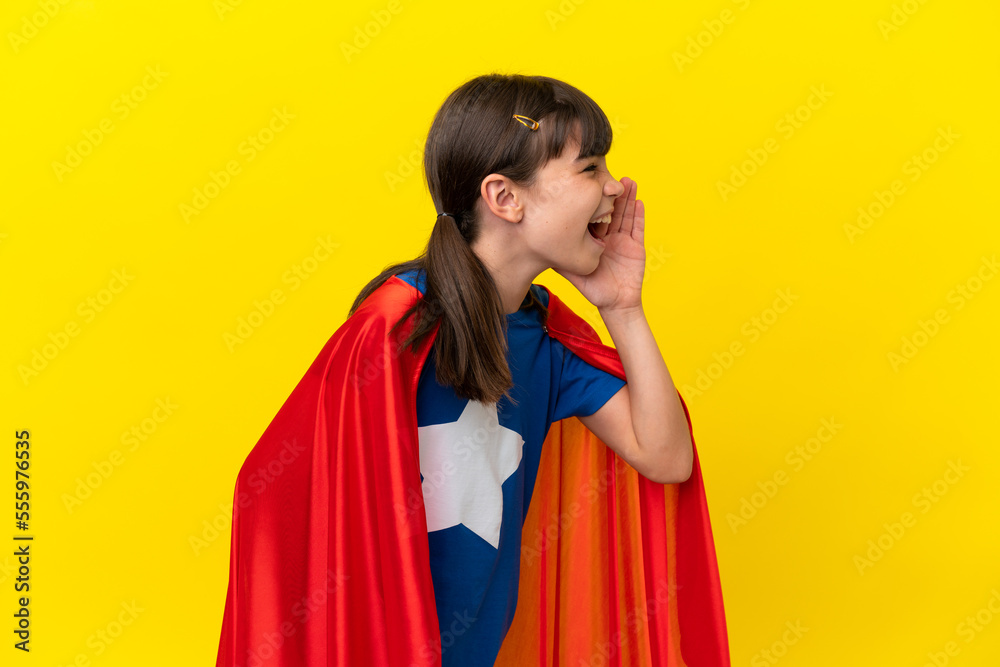 Little super hero kid isolated on purple background shouting with mouth wide open to the lateral Little super hero kid isolated on purple background shouting with mouth wide open to the lateral