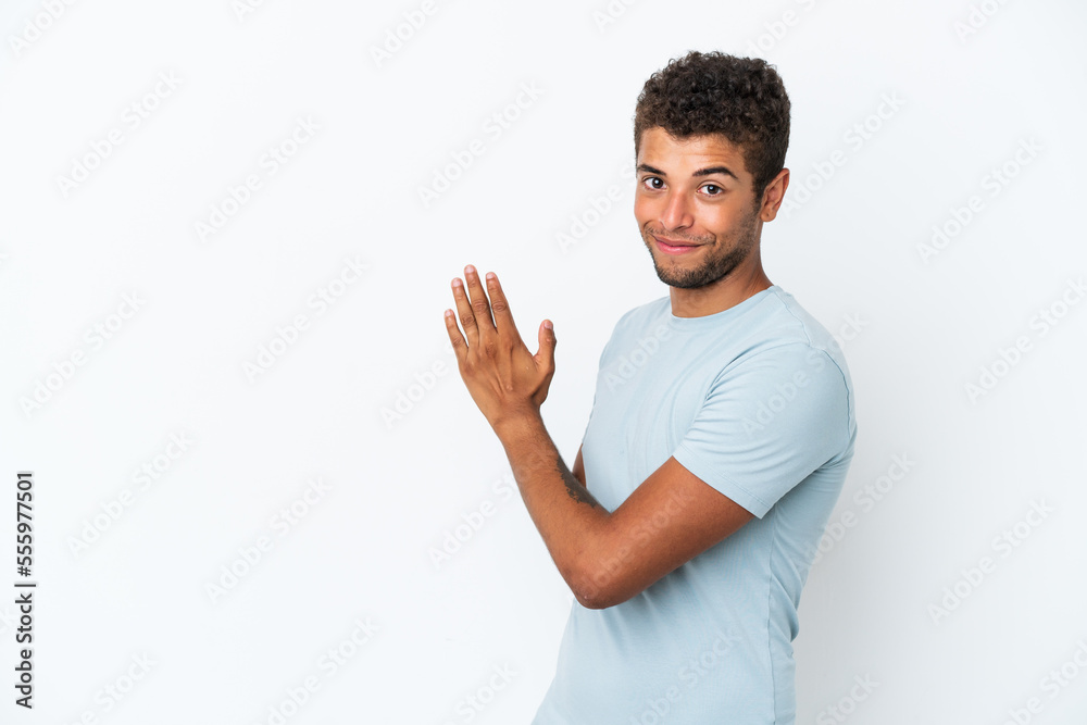 Young handsome Brazilian man isolated on white background scheming something Young handsome Brazilian man isolated on white background scheming something