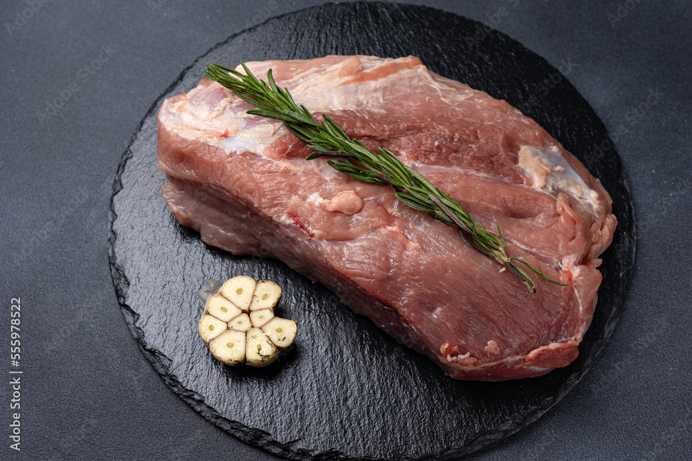 raw meat with spices on a dark background
