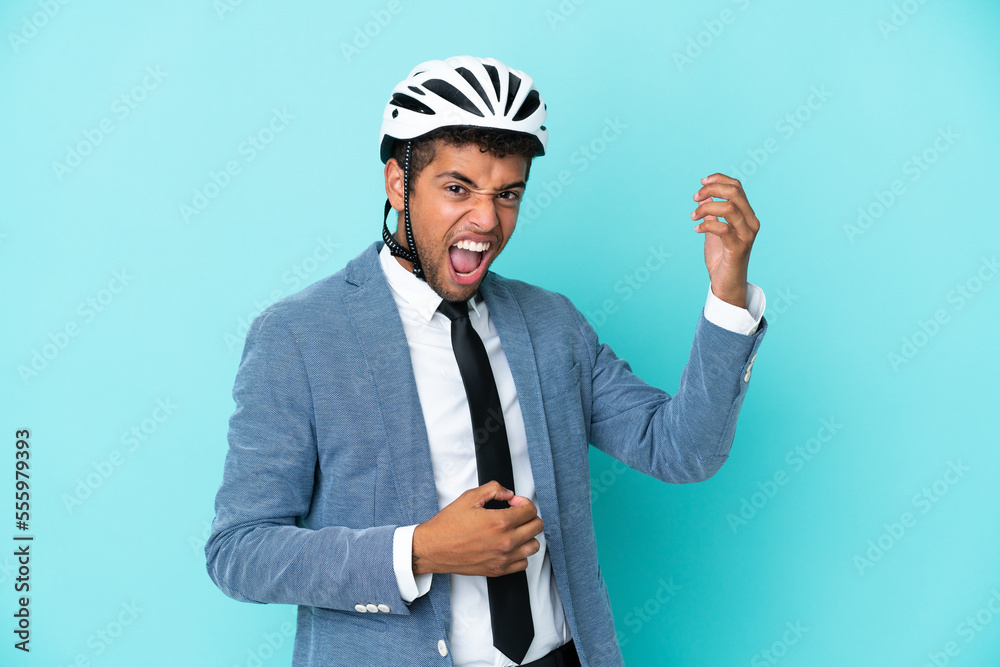 Young business Brazilian man with bike helmet isolated on blue background making guitar gesture Young business Brazilian man with bike helmet isolated on blue background making guitar gesture