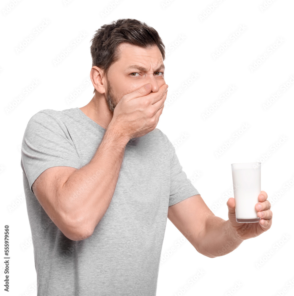 Man with glass of milk suffering from lactose intolerance on white background Man with glass of milk suffering from lactose intolerance on white background