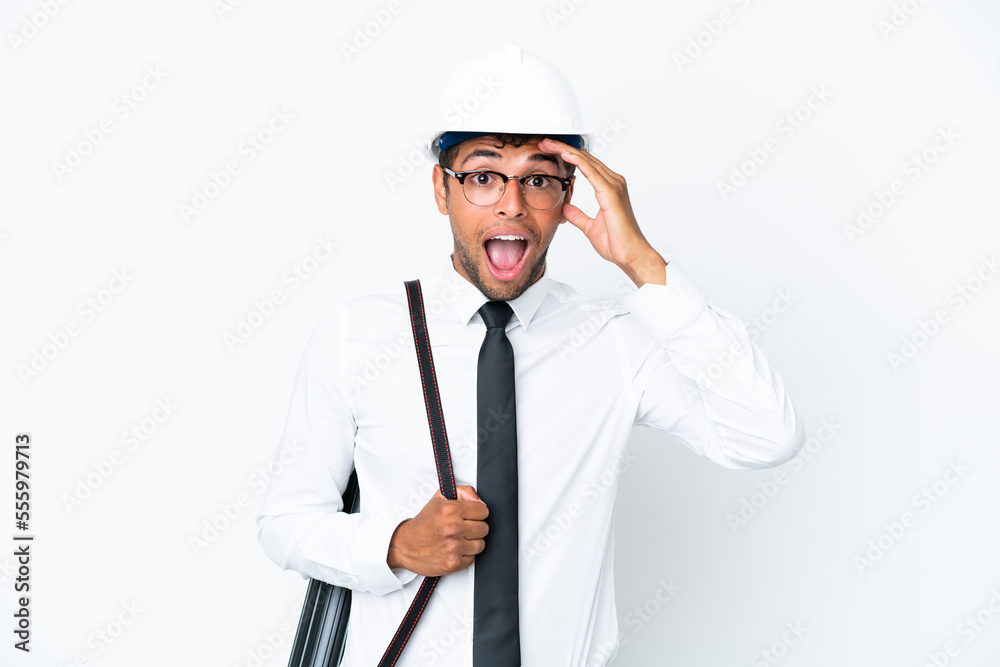 Architect brazilian man with helmet and holding blueprints with surprise expression