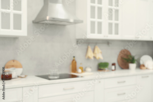 White cosy kitchen with furniture  blurred view. Interior design