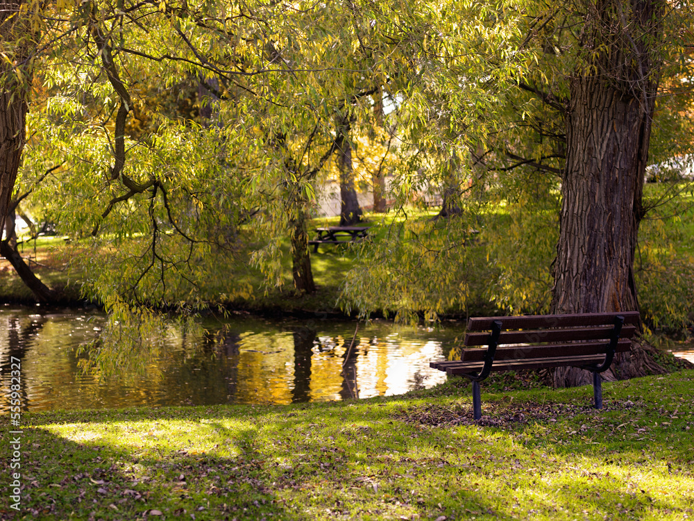 Empty Park Bench by Water, Stratford, Ontario, Canada Empty Park Bench by Water, Stratford, Ontario, Canada