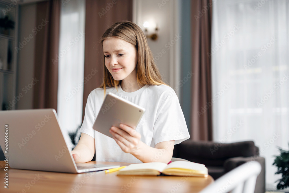 A smart woman student freelancer online training education, at home workplace uses a laptop writes a message to the mail. A smart woman student freelancer online training education, at home workplace uses a laptop writes a message to the mail.