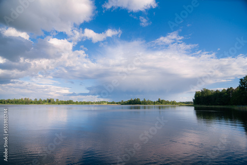 lake with clouds in summer noon © vasvormich