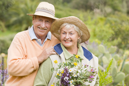 Portrait of Couple, Woman Holding Flowers photo