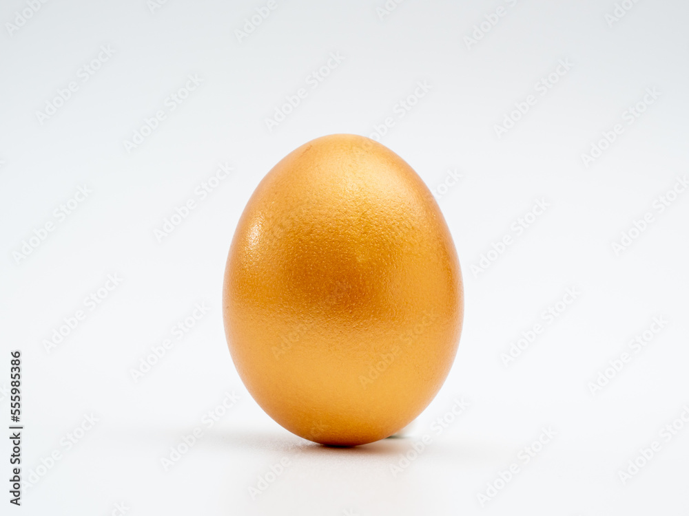 Golden eggs on a white background. Golden chicken eggs. Golden eggs on a white background. Golden chicken eggs.