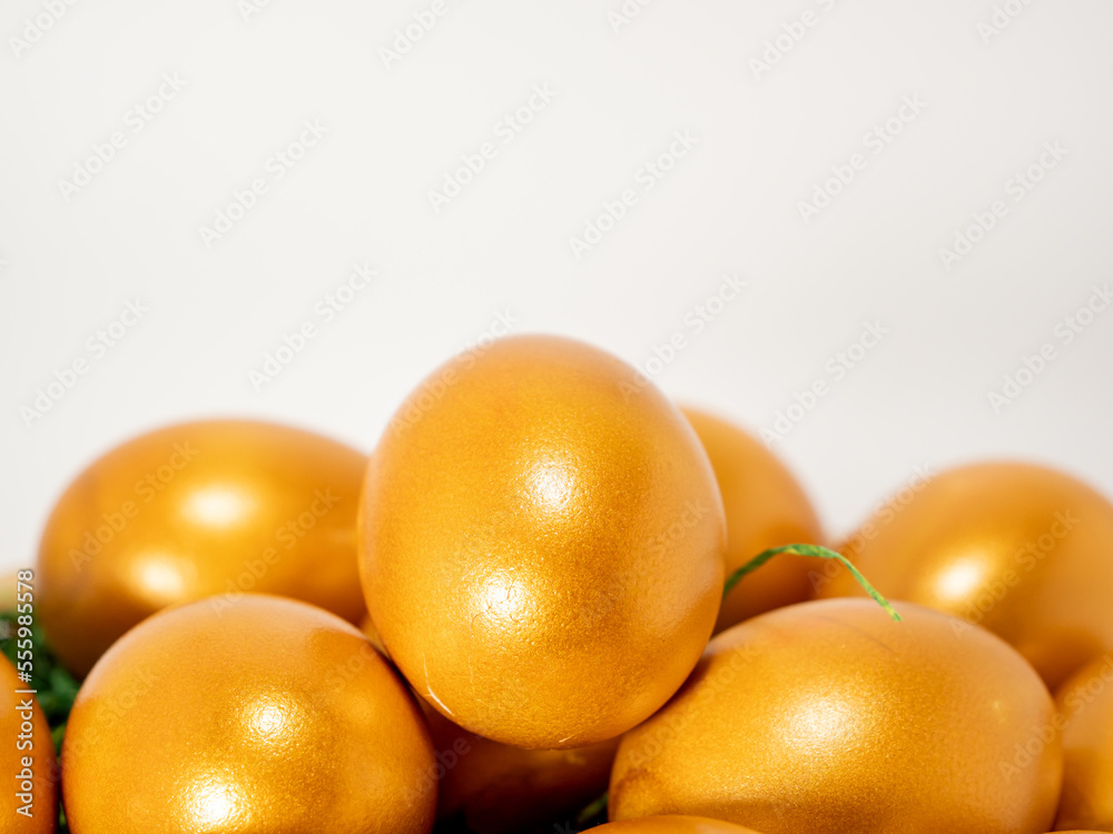 Golden eggs on a white background. Golden chicken eggs. Golden eggs on a white background. Golden chicken eggs.