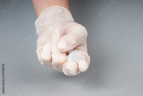 urologist appointment concept, lubricant on the fingers of a doctor in gloves,massage prostate