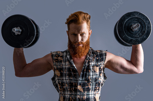 brutal strong man with dumbbells isolated on grey, biceps. brutal strong man with dumbbells © be free