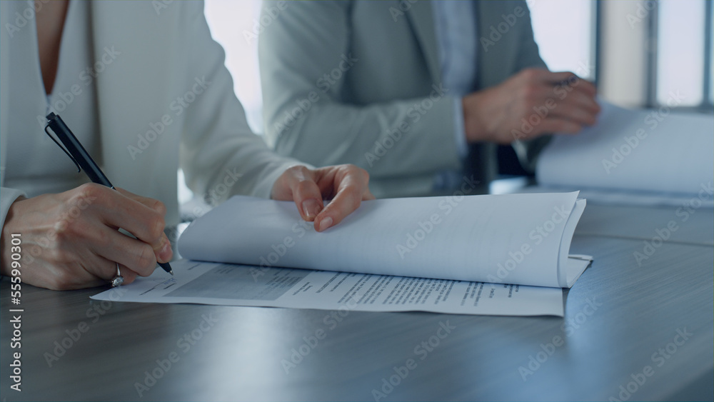 Woman hand holding papers closeup. Managers signing corporate deal with investor Woman hand holding papers closeup. Managers signing corporate deal with investor