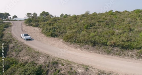 Aerial view of a sport car driving in a woodland, Carmel Forest, Haifa, Israel photo