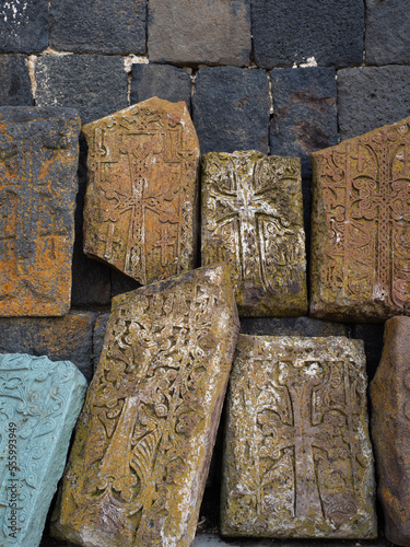 Armenian khachkars at the wall of an ancient monastery. Stone steles with carvings, a national treasure photo