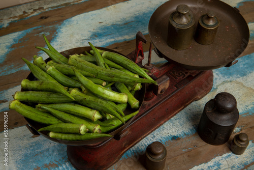 Portion of okra on old scale plate. The text, in Portuguese: maximum load 10 kg, Brazil photo