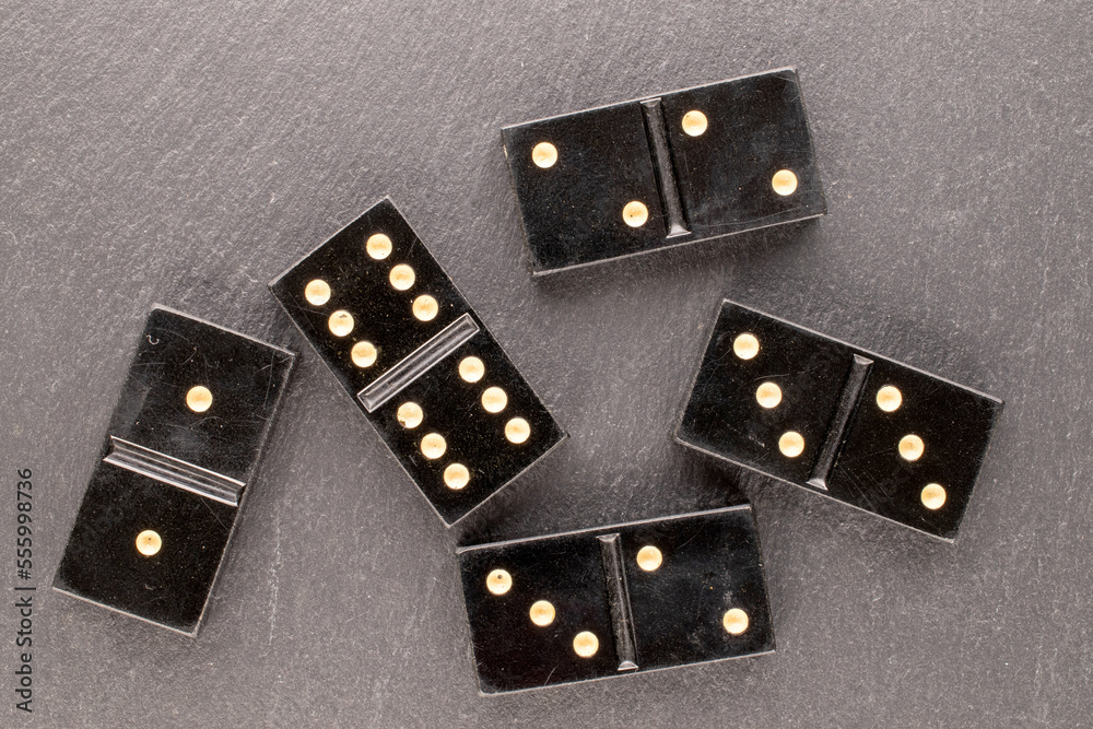 Several dominoes on slate stone, macro, top view. Several dominoes on slate stone, macro, top view.