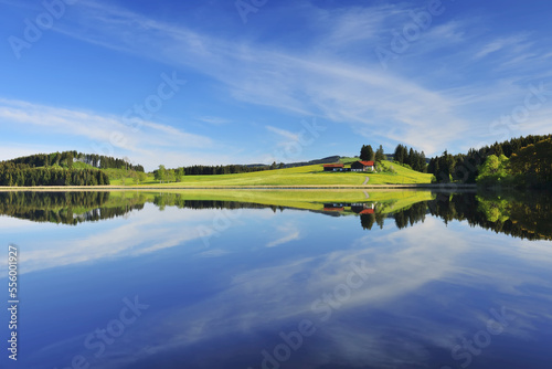 Landscape and Sky Reflecting in Lake, Sameister Weiher, Rosshaupten, Bavaria, Germany photo