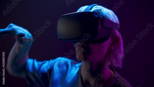 Metaverse man VR glasses playing videogame closeup. Youngster analyzing 3d world © stockbusters