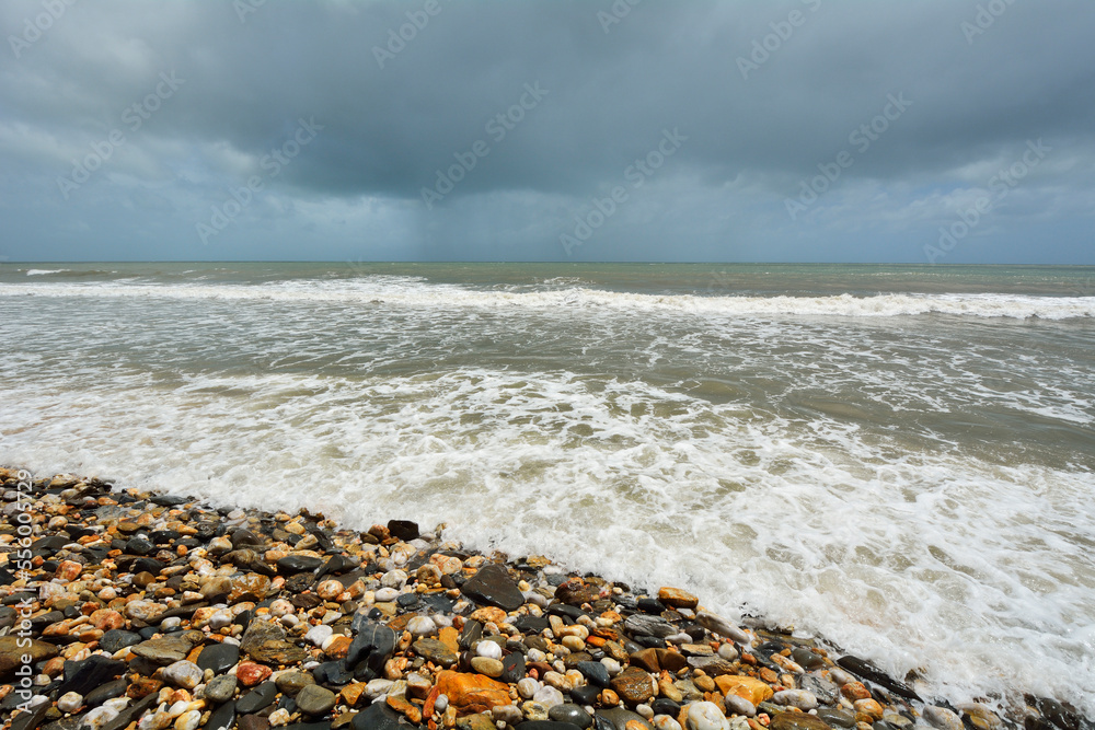 Pebble Beach with Rough Sea and Storm Clouds, Captain Cook Highway, Queensland, Australia Pebble Beach with Rough Sea and Storm Clouds, Captain Cook Highway, Queensland, Australia
