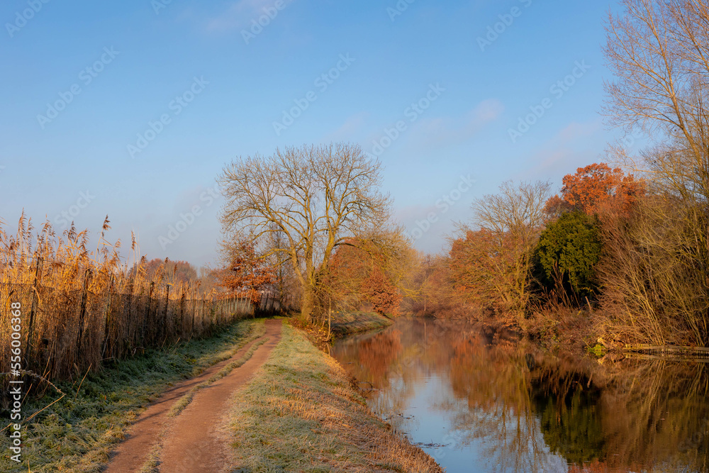 Winter landscape view of white frost in morning, Nature path along the Kromme Rijn river (Crooked Rhine) in Rhijnauwen, Bunnik is a municipality and a village in the province of Utrecht Netherlands. Winter landscape view of white frost in morning, Nature path along the Kromme Rijn river (Crooked Rhine) in Rhijnauwen, Bunnik is a municipality and a village in the province of Utrecht Netherlands.