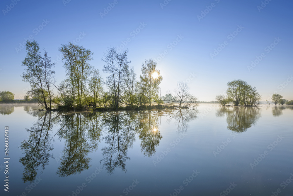 Lake with Island with Trees, Sun and Morning Mist, Streudorf, Lake Altmuhlsee, Weissenburg-Gunzenhausen, Bavaria, Germany Lake with Island with Trees, Sun and Morning Mist, Streudorf, Lake Altmuhlsee, Weissenburg-Gunzenhausen, Bavaria, Germany