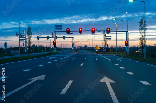 Road Intersection with Red Traffic Light at Dusk, Netherlands photo