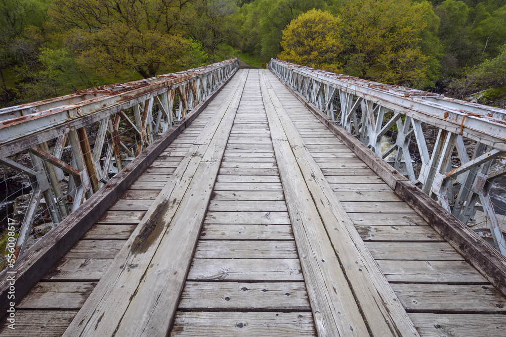 Close-up of wooden bridge over River Orchy at the Eas Urchaidh Waterfall in Scotland, United Kingdom Close-up of wooden bridge over River Orchy at the Eas Urchaidh Waterfall in Scotland, United Kingdom