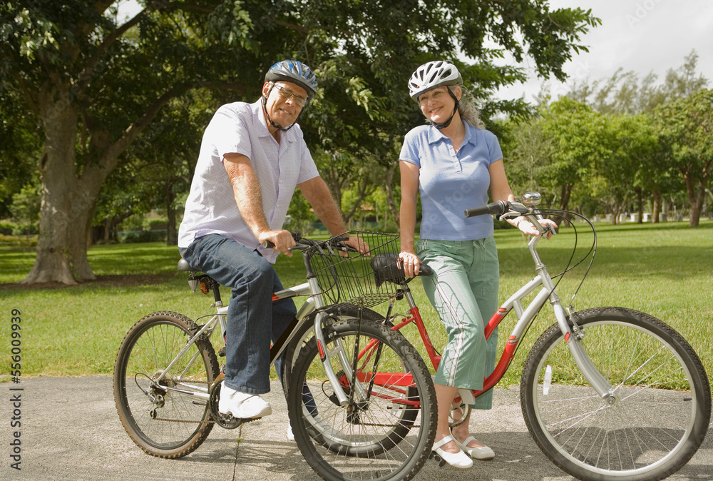 Couple Riding Bikes in the Park Couple Riding Bikes in the Park