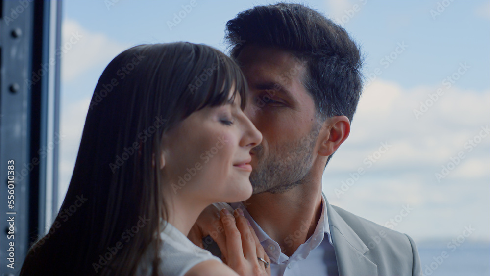 Closeup man kissing woman sea view. Happy couple enjoying romantic date Closeup man kissing woman sea view. Happy couple enjoying romantic date