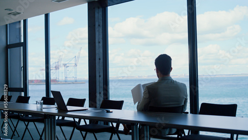 Leader person reading papers at panorama window view. Analyzing deal concept