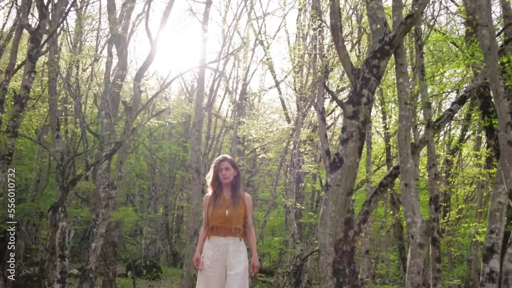 Girl walks in park connecting with nature. a girl walks through the forest enjoying nature. A girl goes on camera in a beautiful forest. reconnecting with nature.hiking woman walk in rainforest jungle Girl walks in park connecting with nature. a girl walks through the forest enjoying nature. A girl goes on camera in a beautiful forest. reconnecting with nature.hiking woman walk in rainforest jungle