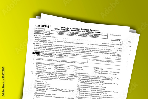 Form W-8BEN-E documentation published IRS USA 44540. American tax document on colored