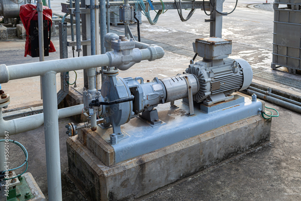 The pump that is adjacent to the electric motor. installed in a chemical factory or oil refinery. Used for sending liquid to various production units of the factory, Concept of industrial works The pump that is adjacent to the electric motor. installed in a chemical factory or oil refinery. Used for sending liquid to various production units of the factory, Concept of industrial works