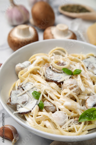 Delicious pasta with mushrooms on white table, closeup